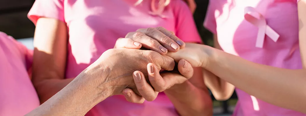 Pink ribbon and hands